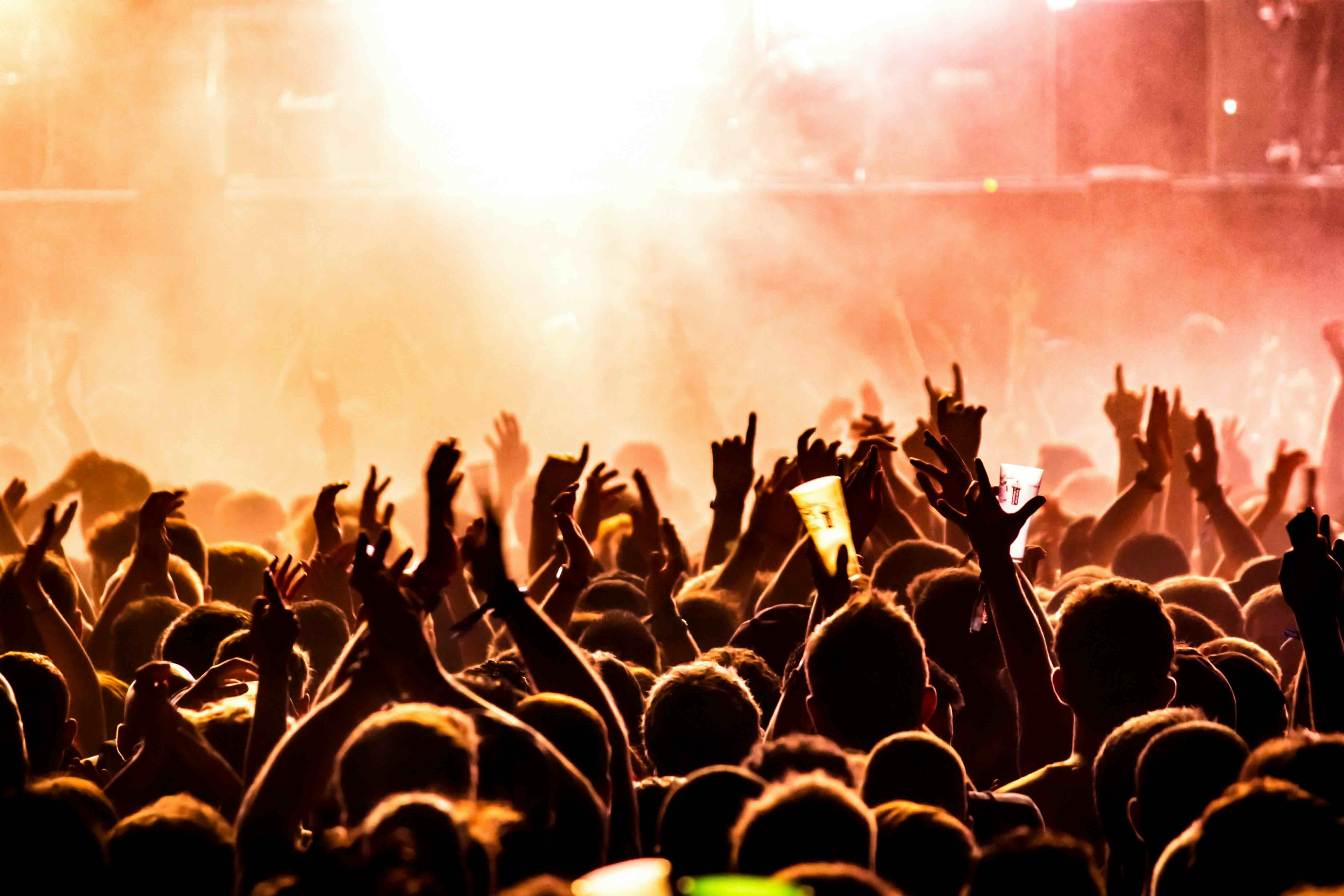 People watching a concert. Photo with a purple hue